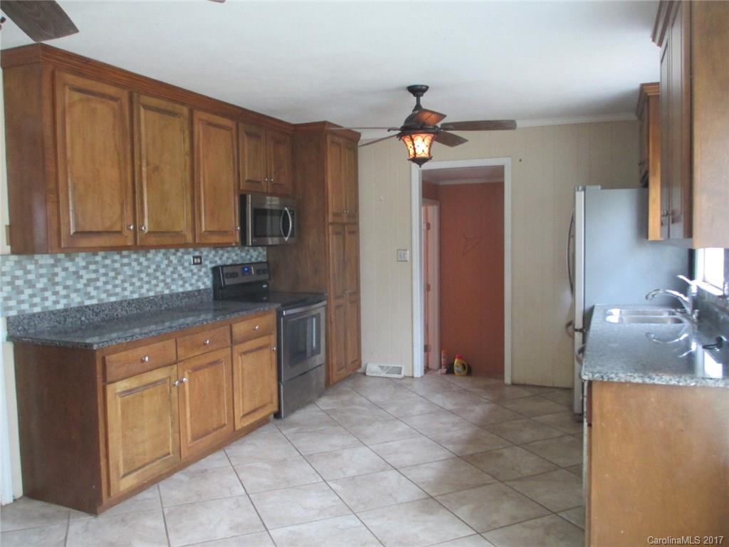 2312 Sunshine Road Lancaster, SC 29720 - Photo 13 of 16 a kitchen with stainless steel appliances granite countertop a sink and cabinets