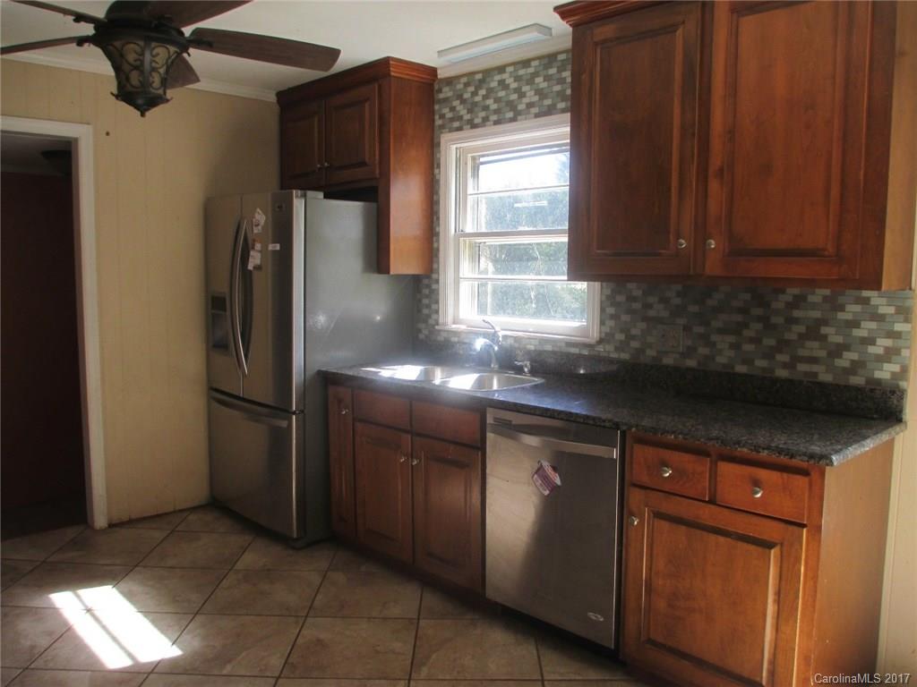 2312 Sunshine Road Lancaster, SC 29720 - Photo 15 of 16 a kitchen with stainless steel appliances granite countertop a refrigerator and a sink