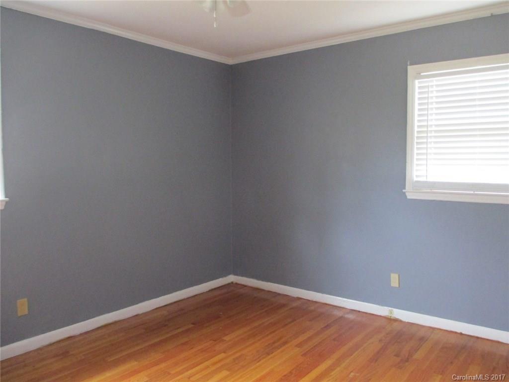 2312 Sunshine Road Lancaster, SC 29720 - Photo 8 of 16 a view of an empty room with wooden floor and a window