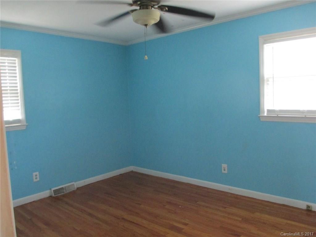 2312 Sunshine Road Lancaster, SC 29720 - Photo 9 of 16 an empty room with wooden floor and windows