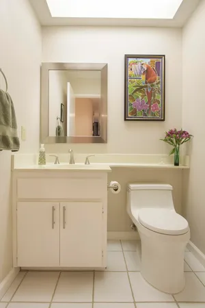 a bathroom with a toilet a sink and mirror