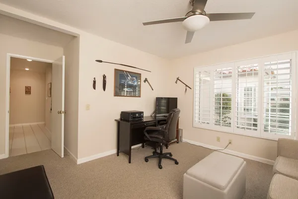 a view of a livingroom with workspace and a window