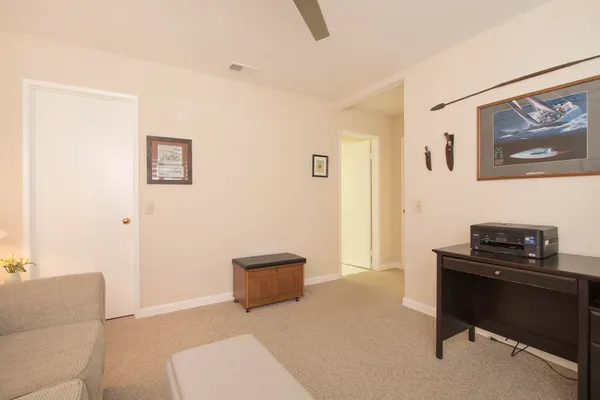 a living room with furniture and a black wall painting