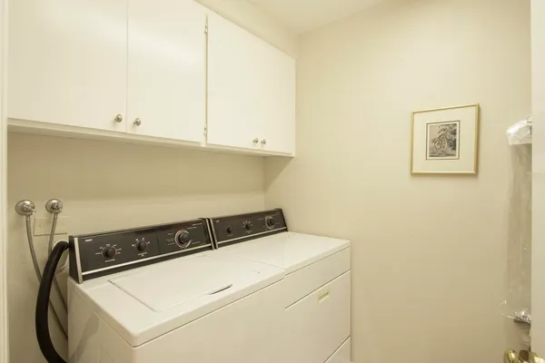 a close up of a utility room with washer and dryer