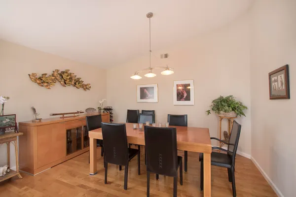 a view of a dining room with furniture and wooden floor