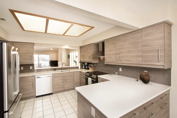 a kitchen with a sink a stove and cabinets