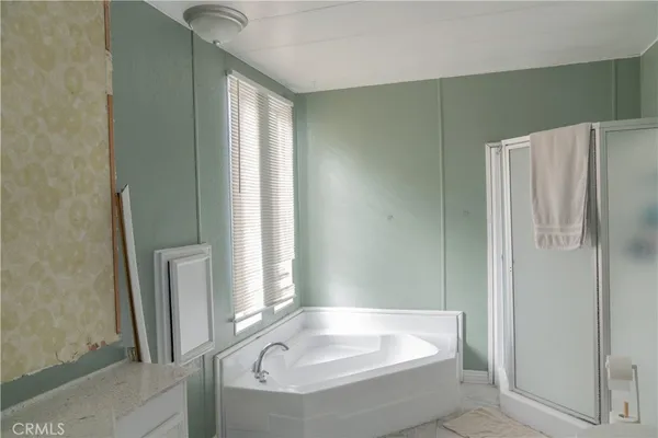 a bathroom with a tub and shower