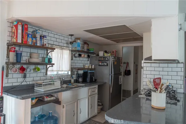 a kitchen with refrigerator and cabinets