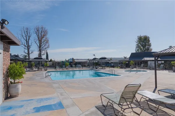 a view of swimming pool with outdoor seating and plants