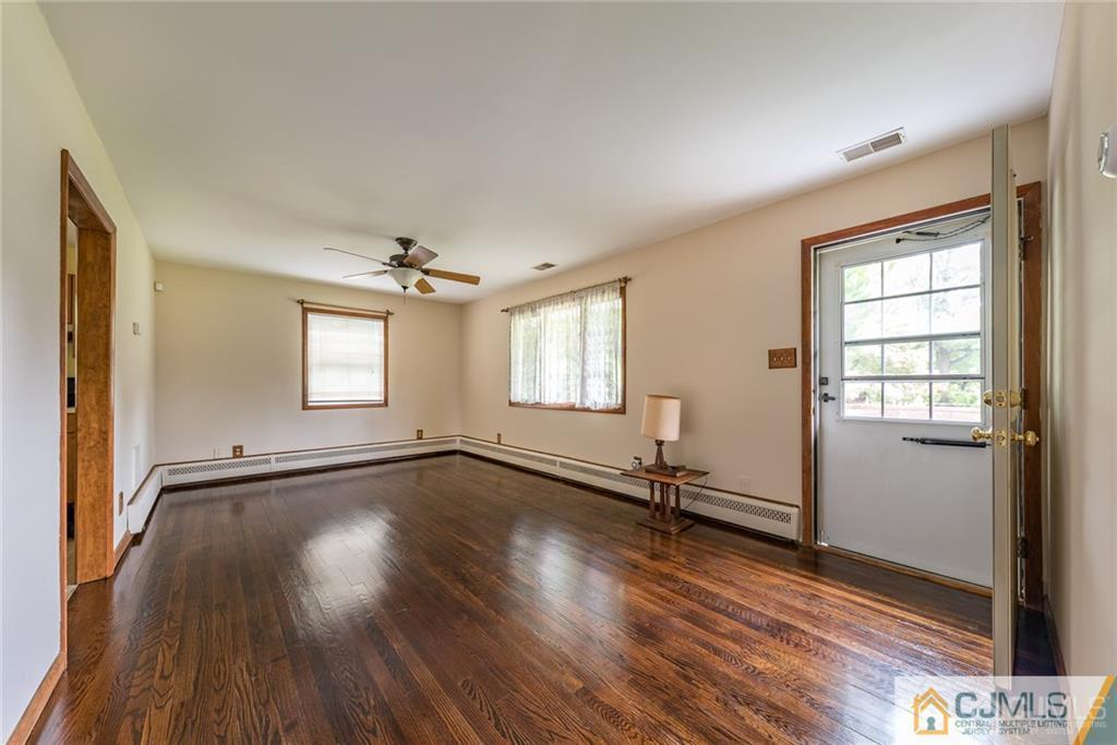 2079 Old York Road Burlington, NJ 08016 - Photo 5 of 25 an empty room with wooden floor and windows