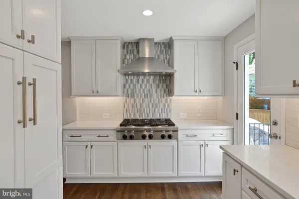 a kitchen with white cabinets and white appliances