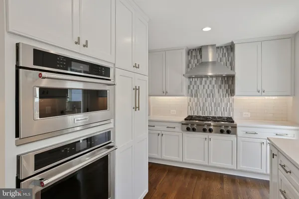 a kitchen with cabinets and steel stainless steel appliances