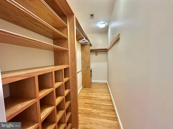 a view of a hallway with wooden floor and entryway