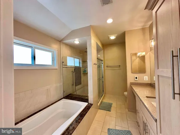 a bathroom with a glass shower door and a sink
