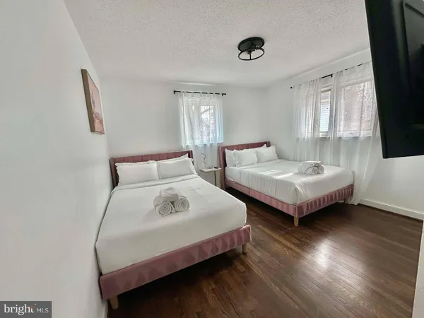 a bedroom with two beds and a window