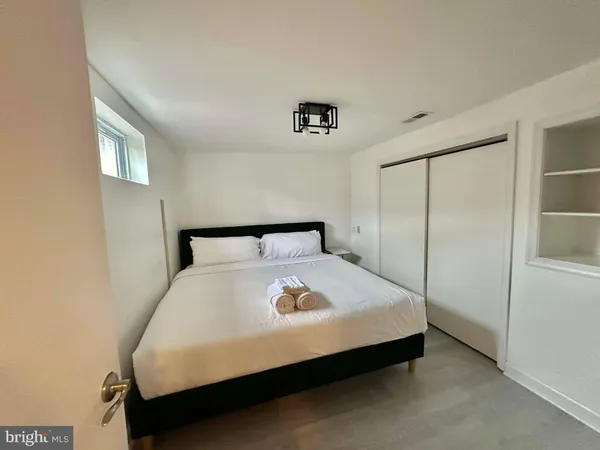 a bedroom with a bed and a window