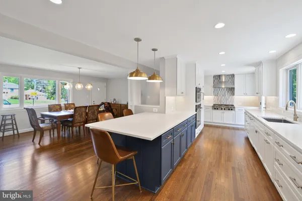 a large kitchen with a table and chairs