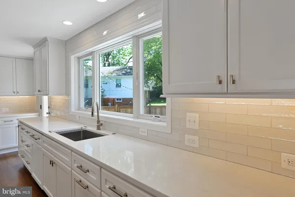 a kitchen with a sink and large window