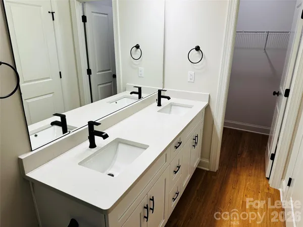 a bathroom with a double vanity sink and a mirror