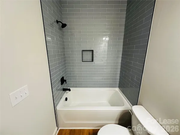 a bathroom with a bathtub and toilet
