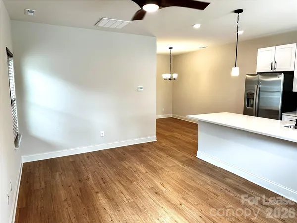 a view of a kitchen with wooden floor