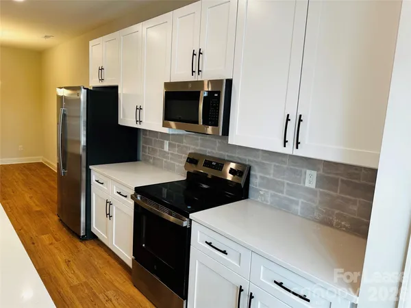 a kitchen with a stove and a microwave
