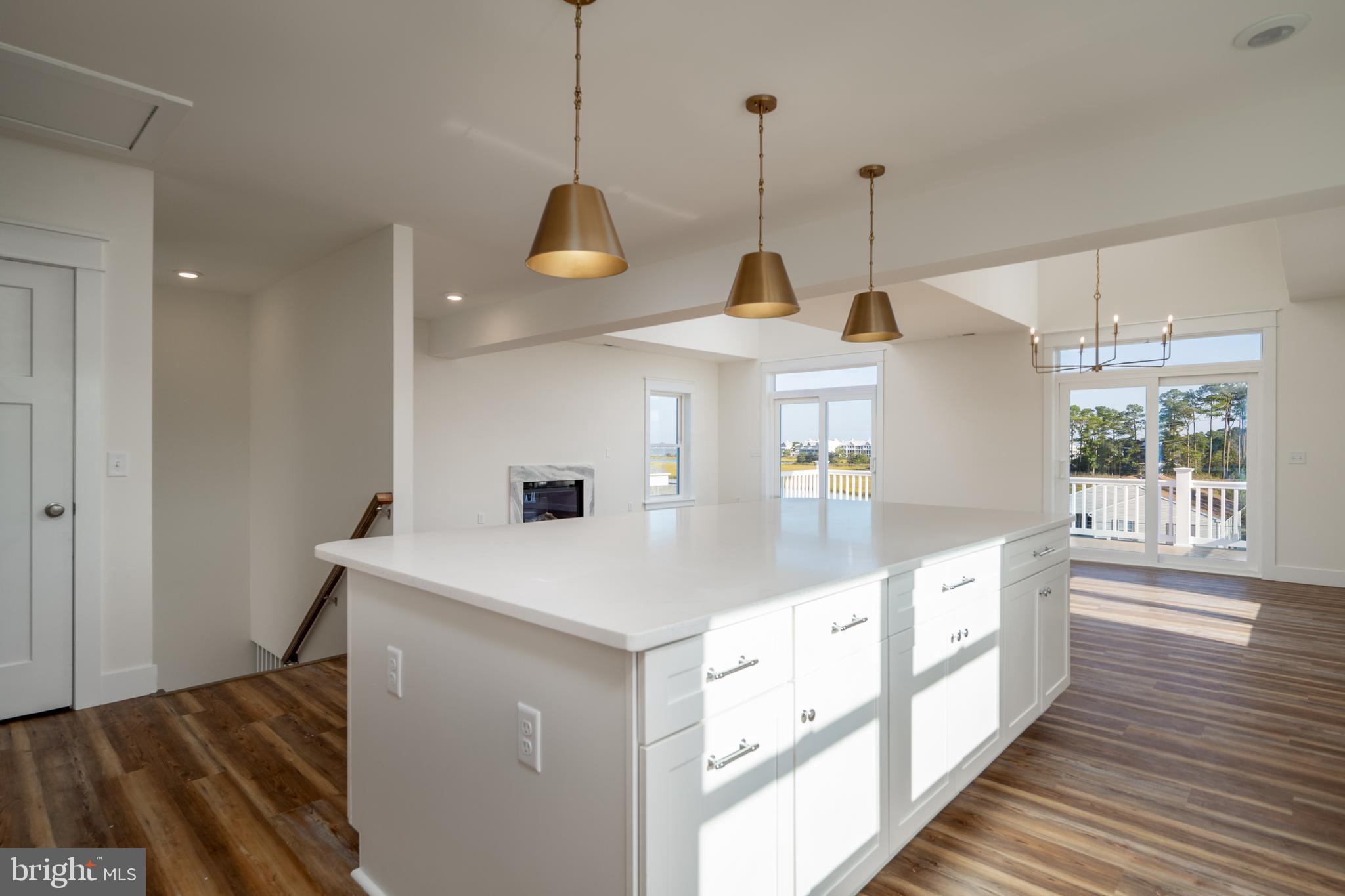 30547 Topside Court Ocean View, DE 19970 - Photo 31 of 39 a kitchen with kitchen island a sink a stove and a wooden floors