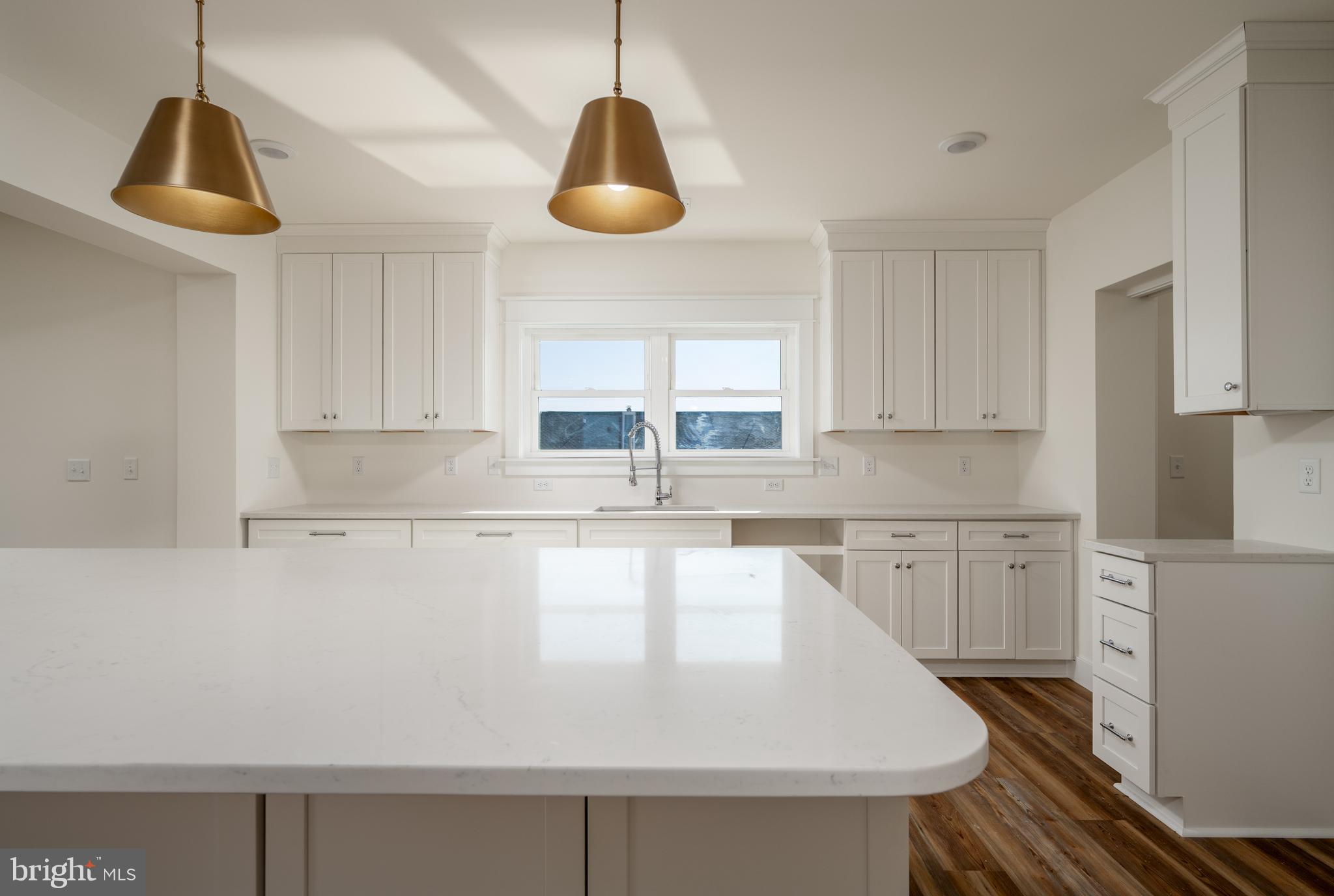 30547 Topside Court Ocean View, DE 19970 - Photo 33 of 39 a large kitchen with stainless steel appliances granite countertop a sink a stove and white cabinets