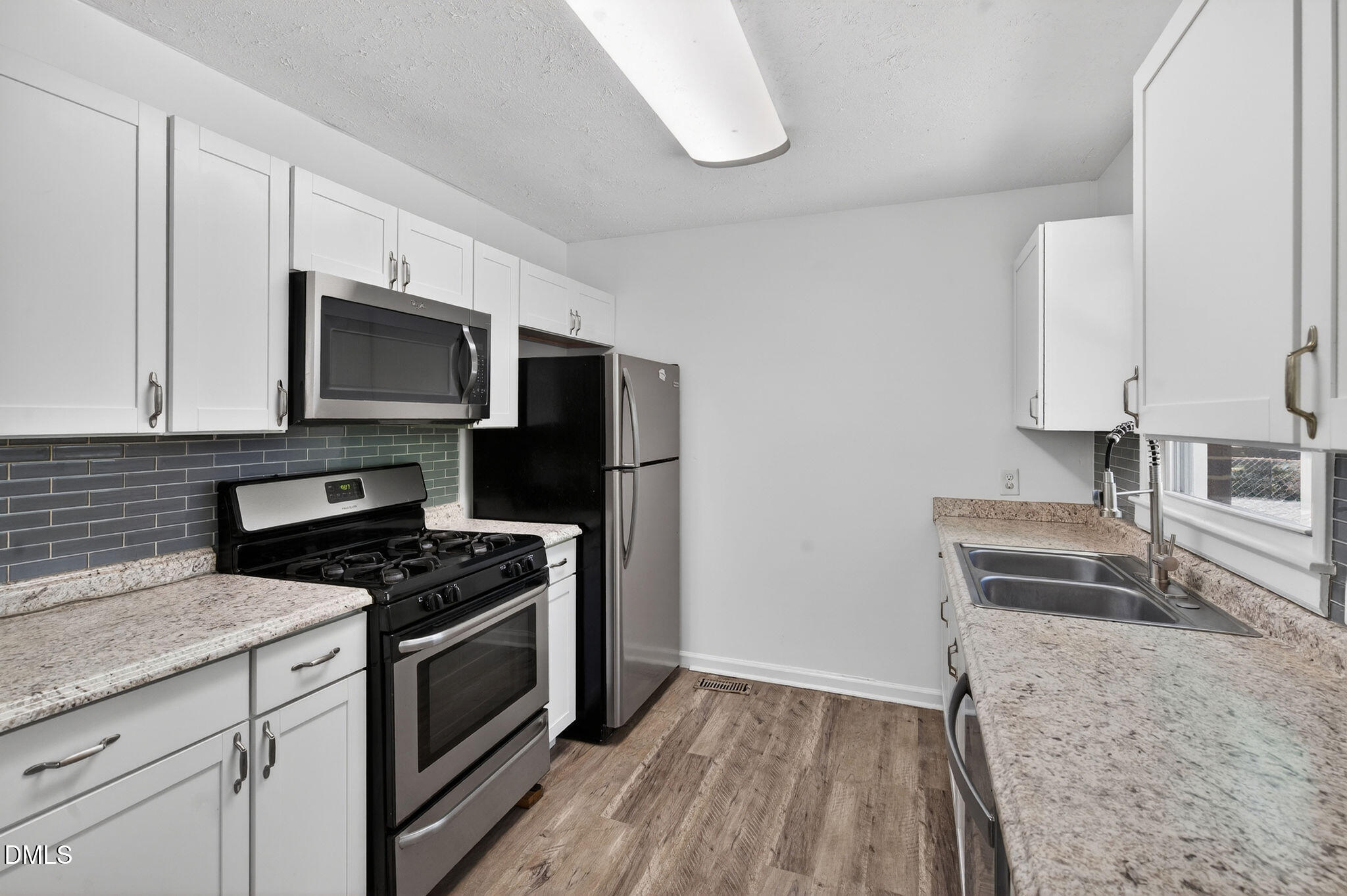 904 Seabrook Road Raleigh, NC 27610 - Photo 6 of 31 a kitchen with granite countertop a sink stove and refrigerator
