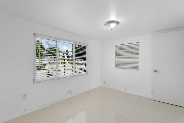 a living room with furniture a rug and a window