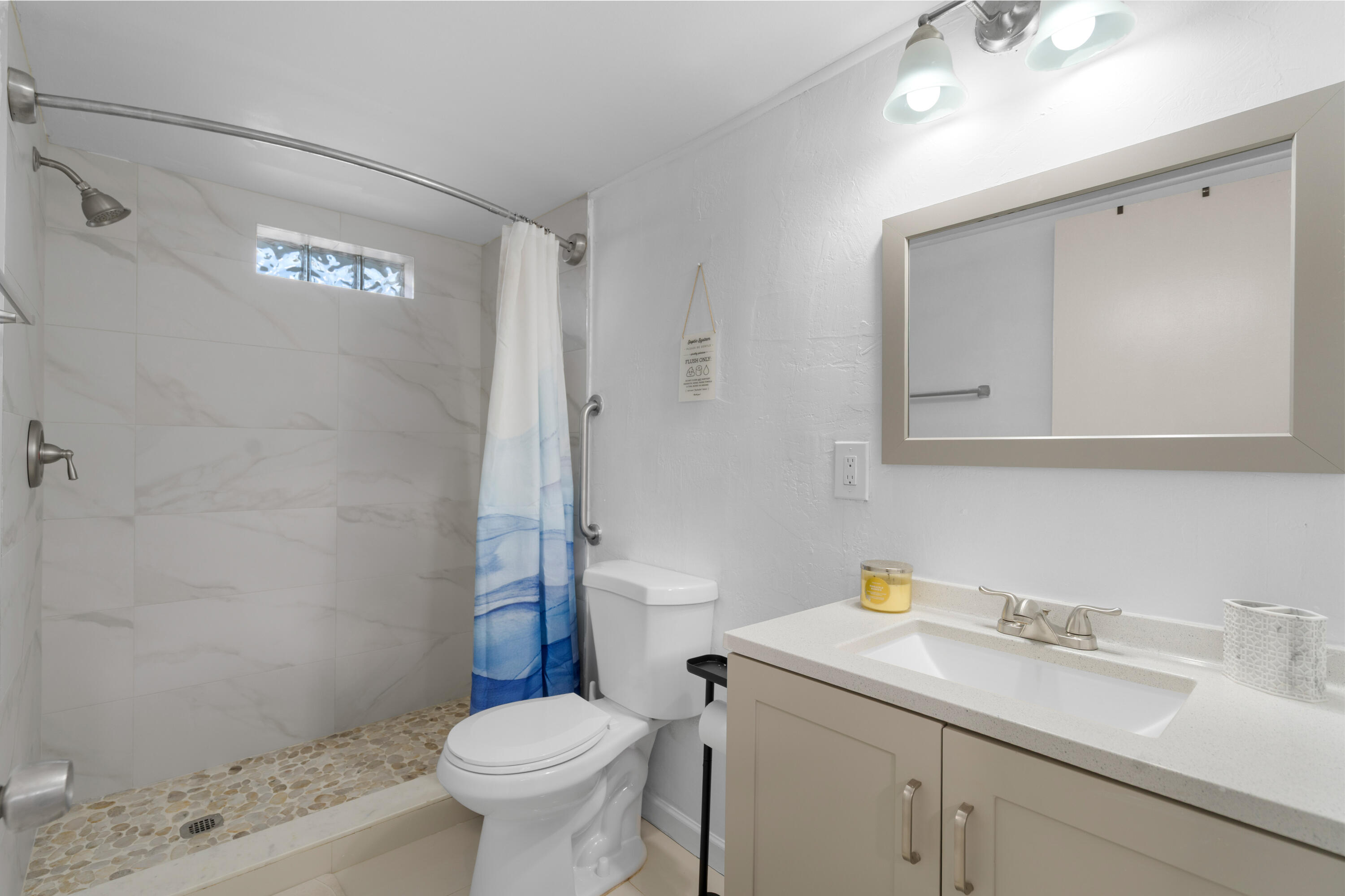 314 Windley Road Key Largo, FL 33037 - Photo 18 of 32 a bathroom with a sink a toilet and a mirror
