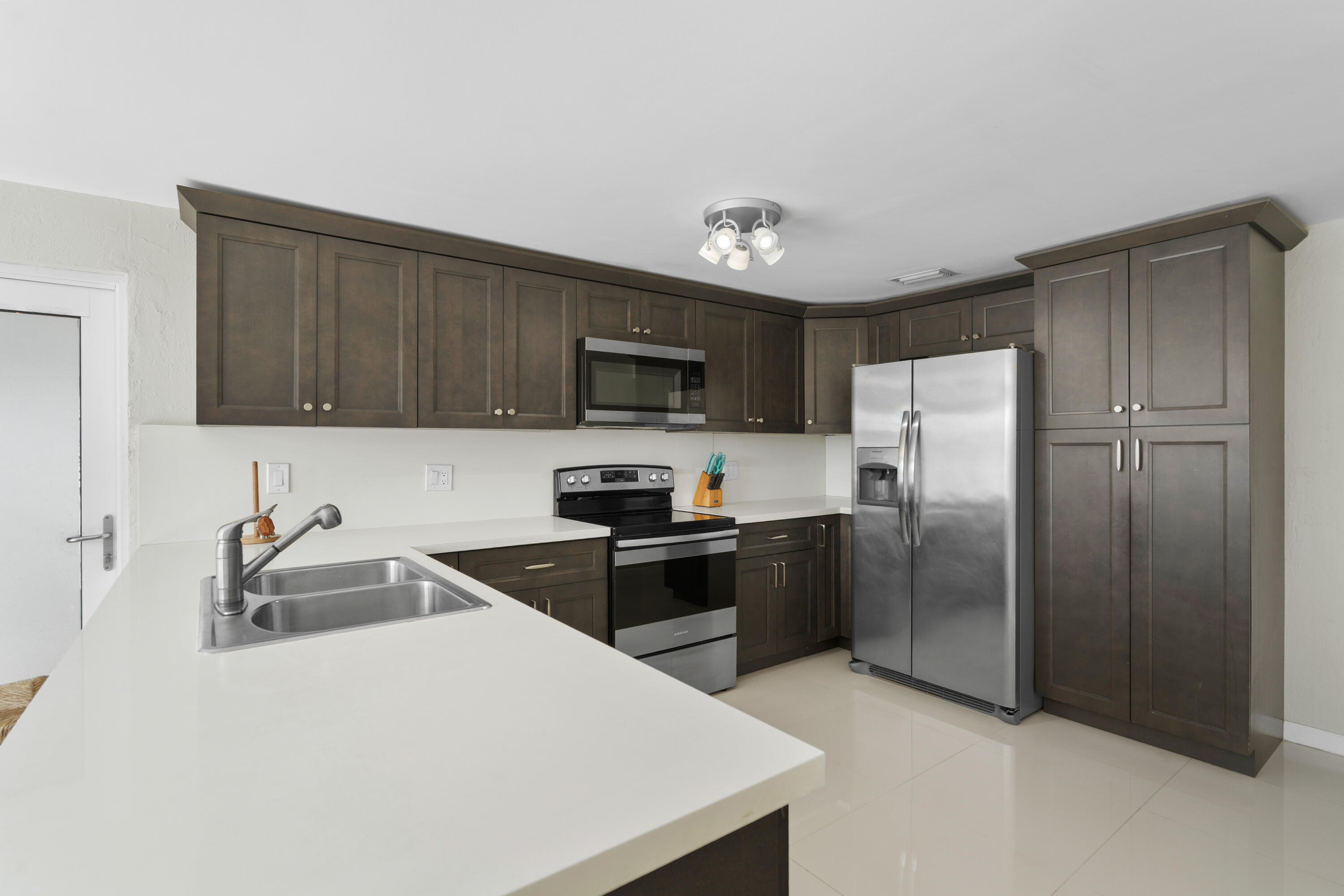 314 Windley Road Key Largo, FL 33037 - Photo 8 of 32 a kitchen with stainless steel appliances granite countertop a refrigerator stove top oven a sink and dishwasher