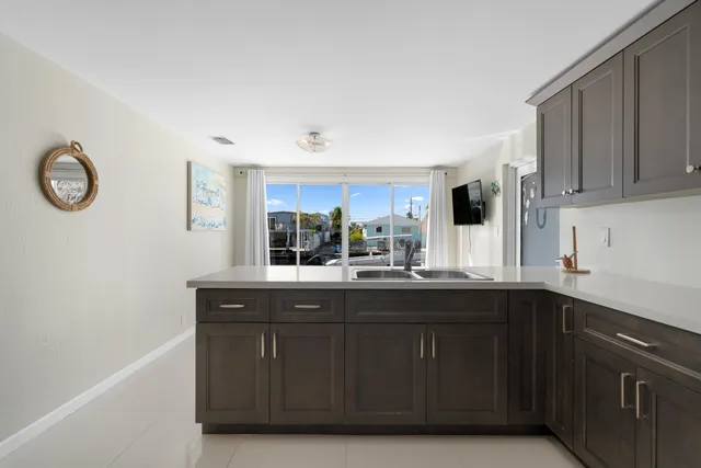 a kitchen with stainless steel appliances granite countertop a stove top oven a sink dishwasher and a microwave oven on the blue kitchen countertops