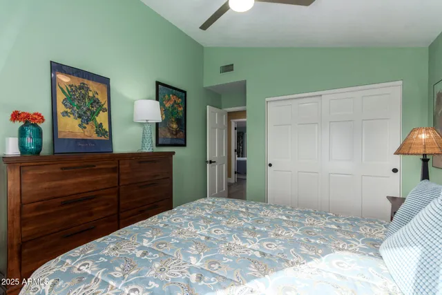 a bathroom with a granite countertop toilet sink and mirror