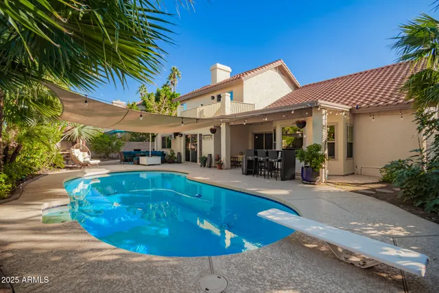 a backyard of a house with table and chairs