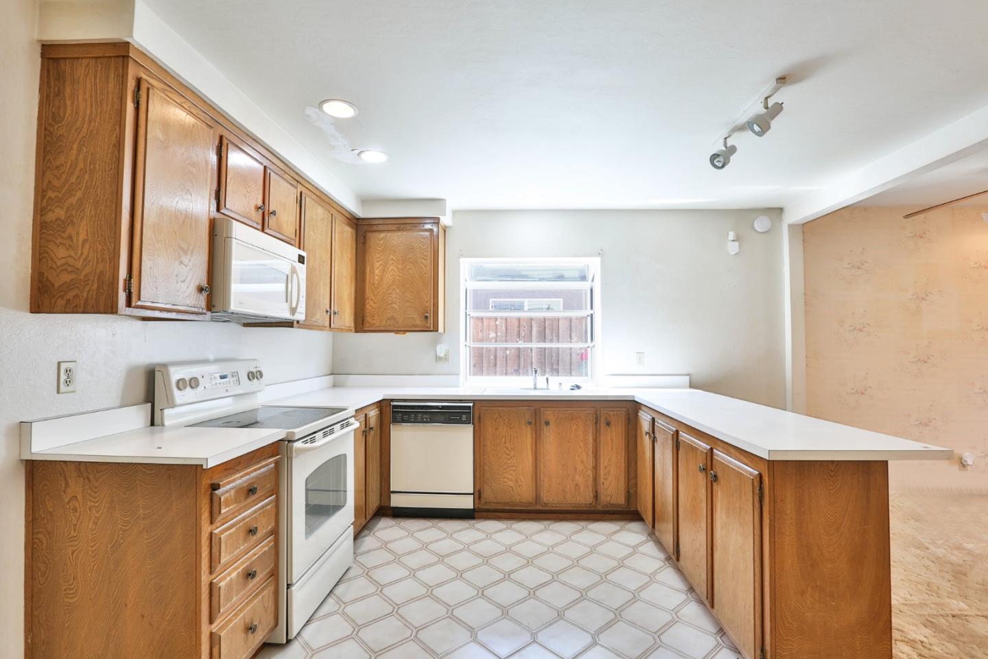 261 Bernal Road San Jose, CA 95119 - Photo 8 of 21 a kitchen with a sink stove and cabinets