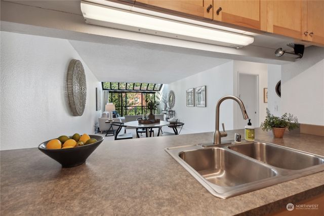a kitchen with a sink and a large window