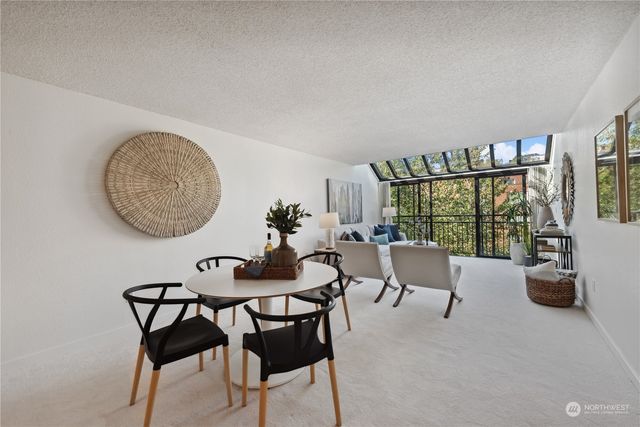 a view of a livingroom with furniture and a floor to ceiling window