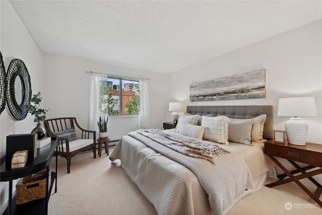 a bedroom with a bed a mirror and a window