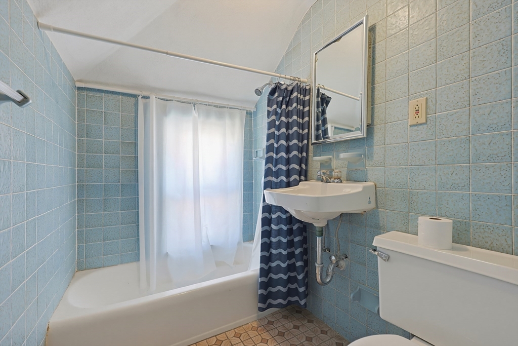 157 Elm Street Somerville, MA 02144 - Photo 16 of 19 a bathroom with a sink toilet and shower