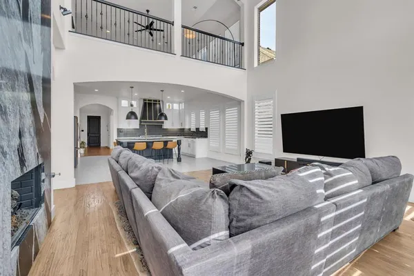 a living room with furniture wooden floor and a flat screen tv