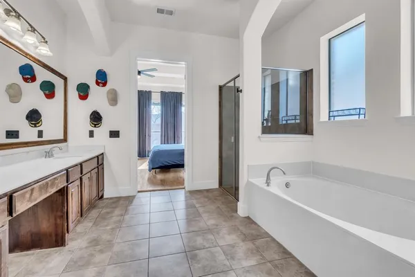 a bathroom with a bathtub sink and mirror