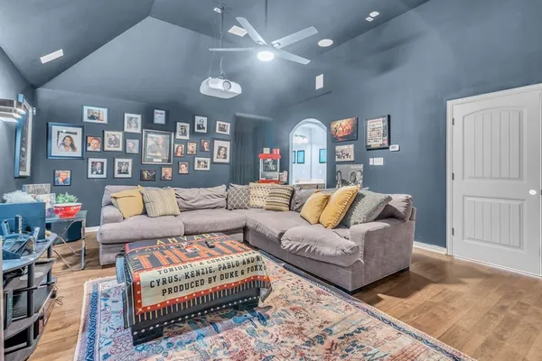 a living room with furniture a rug and a bookshelf