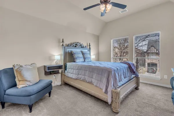 a spacious bedroom with a bed and a couch