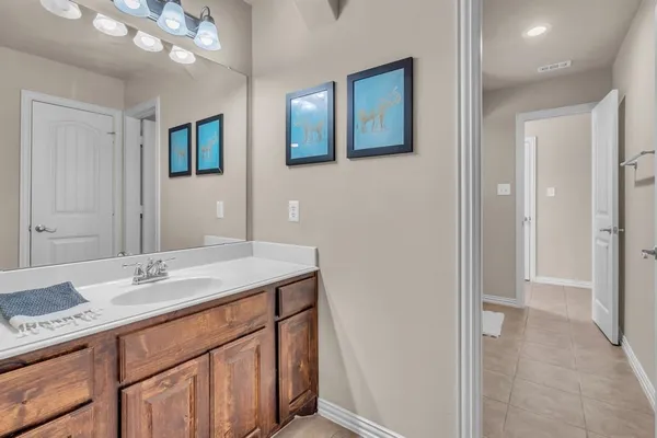 a bathroom with a sink a vanity and a mirror
