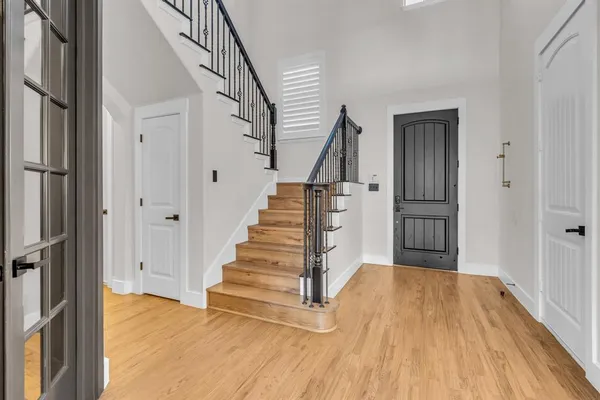 a view of entryway with wooden floor and stairs
