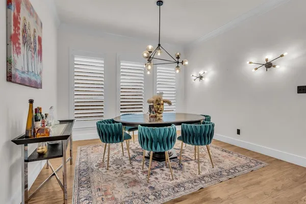 a dining room with furniture a rug and a chandelier