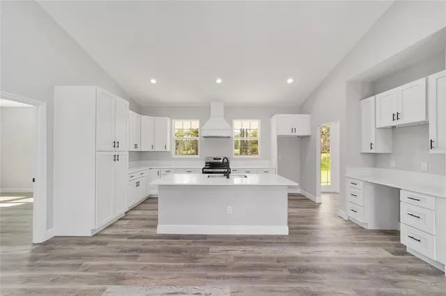 a view of kitchen with center island and stainless steel appliances