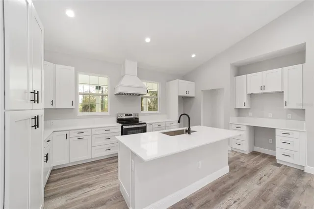 a kitchen with a sink stove and cabinets