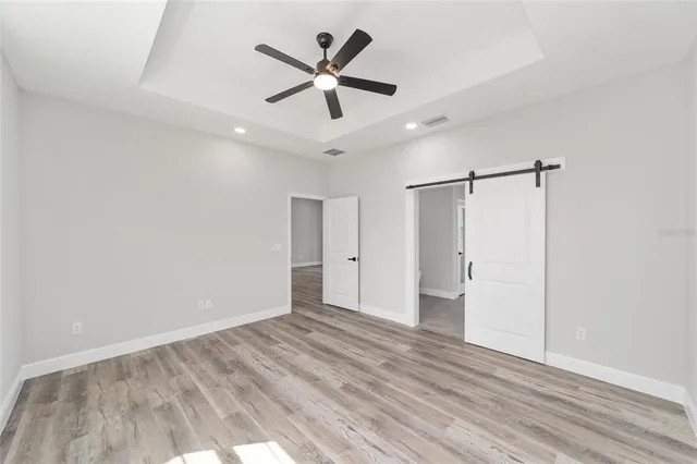 a view of an empty room and wooden floor